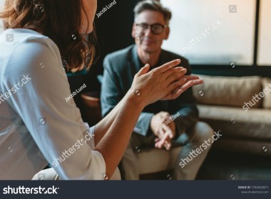 two business people discussing in office lounge businesswoman talking with a male colleague in 1702602871