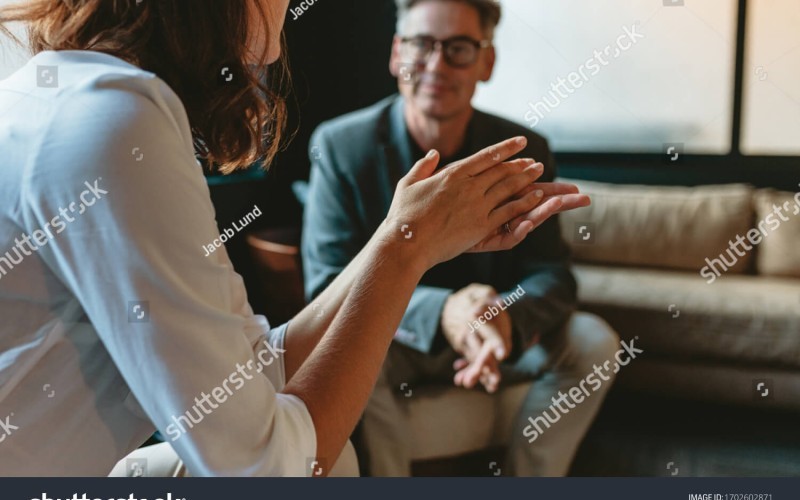 two business people discussing in office lounge businesswoman talking with a male colleague in 1702602871